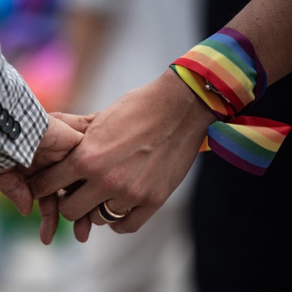 A same-sex couple hold hands during an event to raise awareness of gay rights in Hong Kong on May 25, 2019, one day after Taiwan made history with Asia’s first legal same-sex marriages. Photo: AFP 