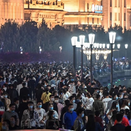 Large crowd of people on tThe Bund along the Huangpu River in Shanghai, China’s premier commercial hub and one of the country’s largest megapolises, with a population of 25 million residents, on May 1, 2020. Photo: AFP