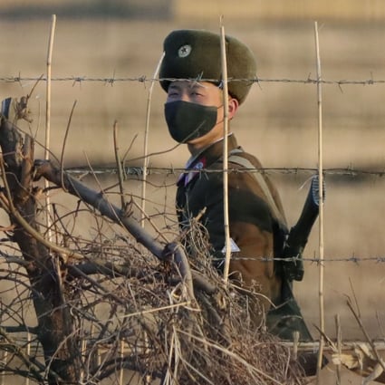 Photo taken from Dandong, China, of a North Korean soldier patrolling the border with China. Photo: Kyodo