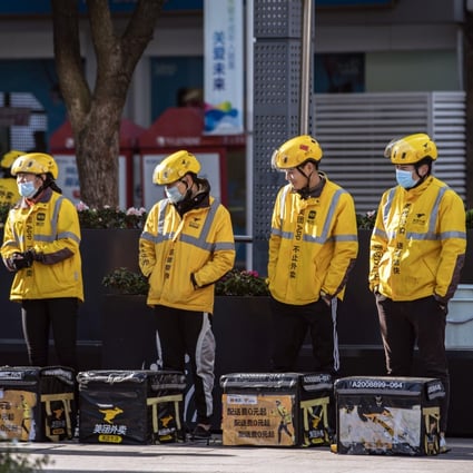 Food delivery couriers for Meituan stand with insulated bags during a morning briefing in Shanghai, China. Photo: Bloomberg