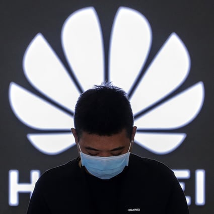 An employee stands inside a Huawei flagship store in Beijing, China, on August 31, 2020. Photo: AP Photo