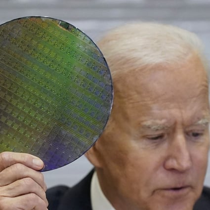 US President Joe Biden holds up a silicon wafer as he participates virtually in the CEO Summit on Semiconductor and Supply Chain Resilience in the White House in Washington on April 12. Photo: AP