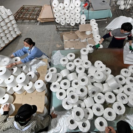 Workers are seen on the production line at a cotton textile factory in Korla, Xinjiang, on April 1. Photo: Reuters