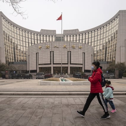 A woman and child walk past the People’s Bank of China building in Beijing on March 4. The inclusion of Chinese bonds in global indices is helping integrate Chinese financial assets into international capital markets, underpinned by domestic reforms aimed at boosting liquidity and transparency. Photo: Bloomberg