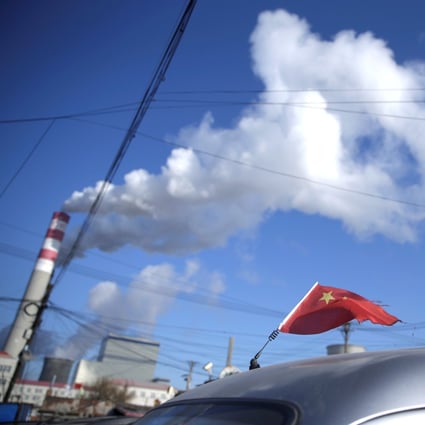A Chinese flag is seen on top of a car near a coal-fired power plant in Harbin, Heilongjiang province, in November 2019. Last year, China added 38.4GW in new coal-fired power – three times the rest of the world combined. Photo: Reuters