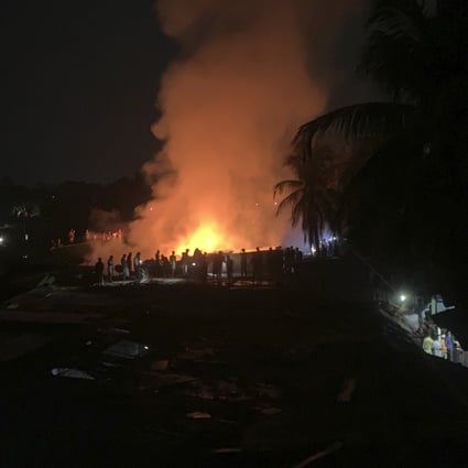 Flames rise from a fire in a makeshift market near a Rohingya refugee camp in Bangladesh on April 2. Photo: AP