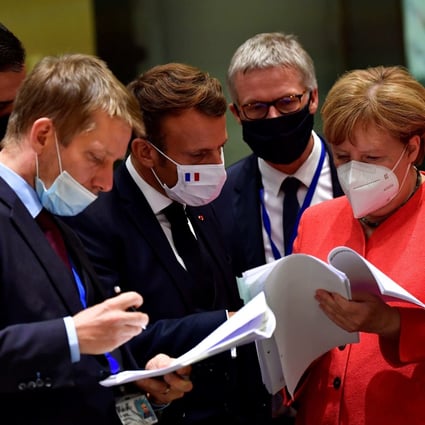 Spanish Prime Minister Pedro Sanchez (left), French President Emmanuel Macron (centre) and German Chancellor Angela Merkel (right) examine documents during an EU summit in Brussels last July. Photo: AFP