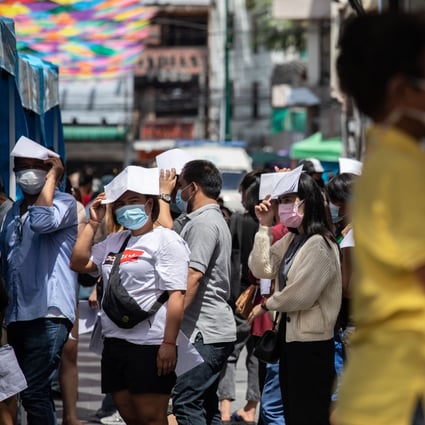 People stand in line for a swab test at a temporary Covid-19 testing site in Bangkok on Monday. Photo: Bloomberg