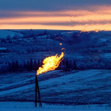 A natural gas flare on an oil well pad burns as the sun sets outside Watford City, North Dakota, on January 21, 2016. Photo: Reuters