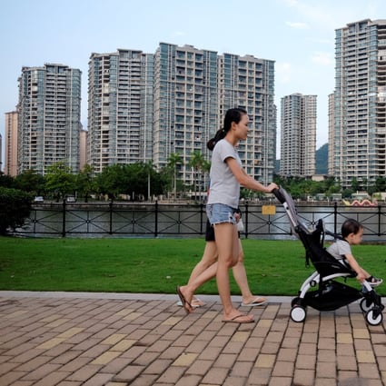 People walk past a residential property development by Agile Property in Zhongshan, Guangdong. Photo: Reuters