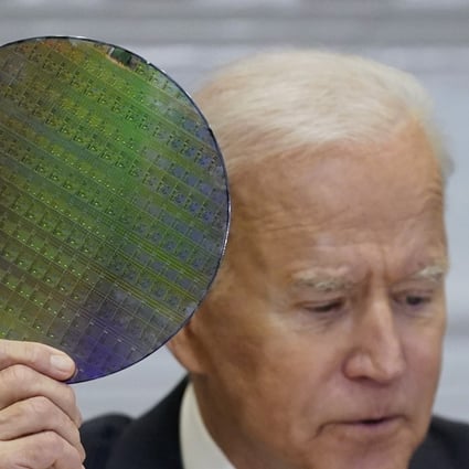 US President Joe Biden holds up a silicon wafer as he participates virtually in the CEO Summit on Semiconductor and Supply Chain Resilience in the White House, April 12, 2021. Photo: AP