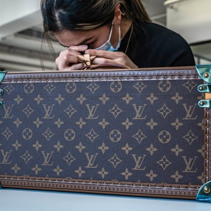 An employee authenticates a pre-owned Louis Vuitton product for Vestiaire Collective. Shoppers in Asia are finally warming up to the idea of buying pre-owned. Photo: Bloomberg