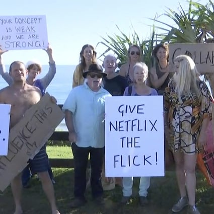 Protesters display placards at Byron Bay, Australia, this week in opposition to the filming of a reality television series that some fear will damage the reputation of the tourist town. Photo: Australian Broadcasting Corporation via AP