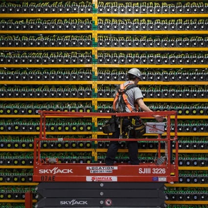 A technician inspects bitcoin mining rigs at Bitfarms in Saint-Hyacinthe, Quebec, Canada, in March 2018. Photo: AFP 