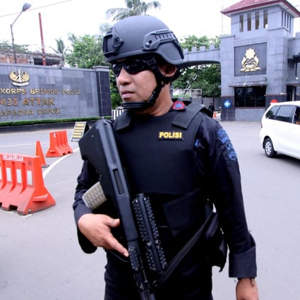 A police officer stands guard outside the Mobile Police Brigade headquarters. Photo: Reuters