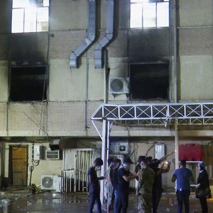 First responders work at the scene of a fire at a hospital in Baghdad after oxygen cylinders reportedly exploded late on Saturday. Photo: AP