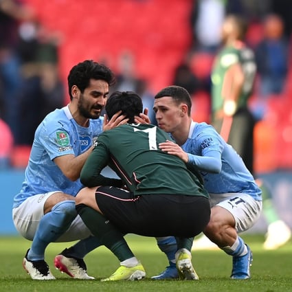 Son Heung-min of Tottenham Hotspur is consoled by Ilkay Gundogan and Phil Foden of Manchester City after the Carabao Cup Final at Wembley Stadium. Photo: Tottenham Hotspur FC via Getty Images