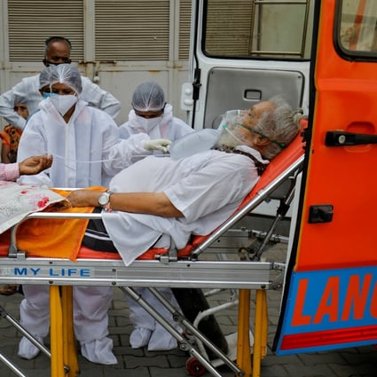 A patient wearing an oxygen mask is wheeled inside a Covid-19 hospital for treatment in Ahmedabad. Photo: Reuters