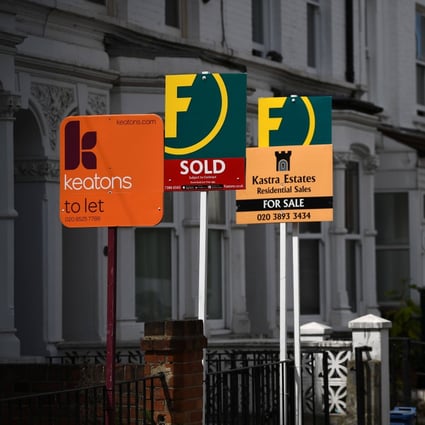 Property agents’ boards are pictured on a residential street in Hackney, east London. Photo: AFP