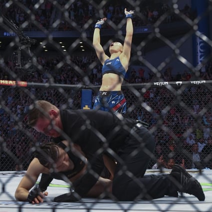 Rose Namajunas celebrates as the referee kneels over Zhang Weili at UFC 261. Photo: AP