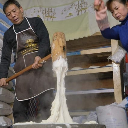 Wang and his wife pounding the rice into a sticky paste. Photo: Goldthread