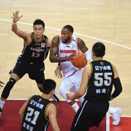 Sonny Weems, of the Guangdong Southern Tigers, dribbles through a crowd of Liaoning Flying Leopards players in game one of the 2020-21 Chinese Basketball Association finals. Photo: Xinhua