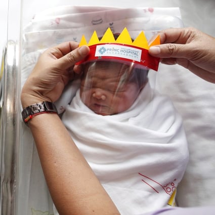 A Thai nurse puts face shields on newborn babies as a precaution against the coronavirus, at the Princ Hospital Suvarnabhumi in Samut Prakan province, Thailand, on April 8, 2020. Pregnant women have been among the most vulnerable yet under-reported groups during the pandemic. Photo: EPA-EFE