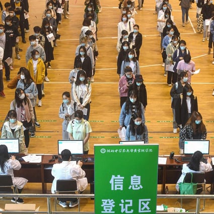 University students in Wuhan queue to receive Sinopharm Covid-19 jabs, but experts say not enough people are being vaccinated nationally. Photo: AFP