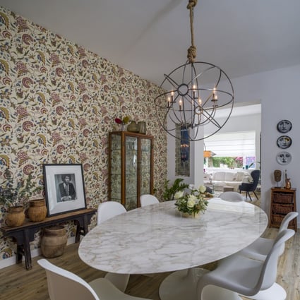 The decorative focal point of Fé Valvekens’ dining room in Stanley is its hand-painted wallpaper. Photo: John Butlin