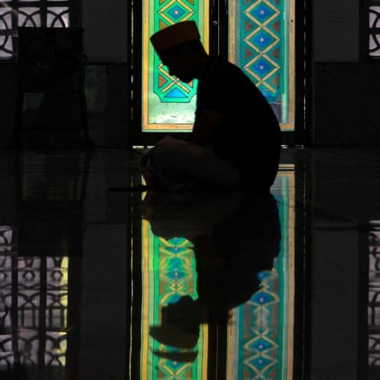 People take part in Friday prayers in Banda Aceh. Photo: AFP 