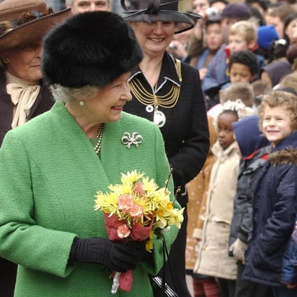 How do you get Queen Elizabeth’s attention in a crowd? Try being a kid, or bringing a corgi with you. Photo: WPA
