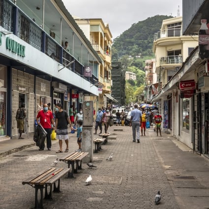 Pedestrians walk on a street in the capital Victoria, Seychelles. File photo: AP