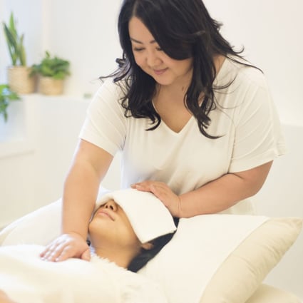 Reiki, performed here by Hong Kong healer Corie Chu, is an alternative therapy in which energy is channelled to treat physical and emotional woes. It is gaining followers as an effective complement to Western medicine. Photo: Camilla W Photography