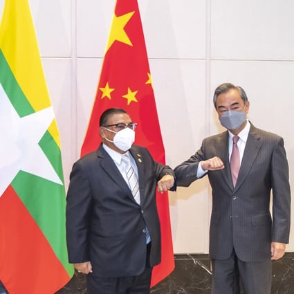 China’s Foreign Minister Wang Yi (right) bumps elbows with junta representative Wunna Maung Lwin at a June 8 meeting marking the 30th anniversary of formal relations between China and Asean. Photo: Xinhua