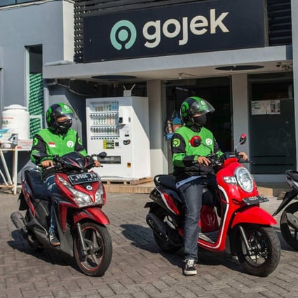 Gojek riders wait for delivery orders at a distribution centre in Surabaya. Photo: AFP 