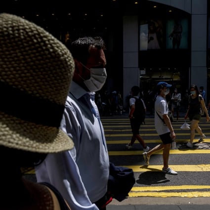 People walk past a pedestrian crossing during lunch hour in the Central district of Hong Kong, on June, 7. Photo: Bloomberg