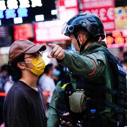 A police officer asks member of the public to move away during an anti-government protest in Hong Kong on September 6, 2020. Photo: ZUMA Wire/dpa