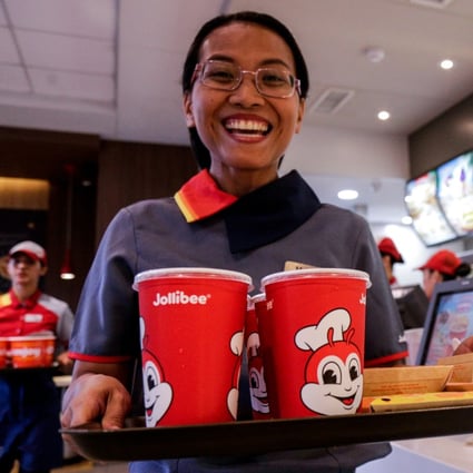 A Jollibee worker serves a meal at an outlet in Pasig City. Photo: SCMP/Jansen Romero