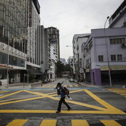 A man walks along a deserted street during a nationwide lockdown in Malaysia. Photo: SOPA Images via ZUMA Wire/dpa