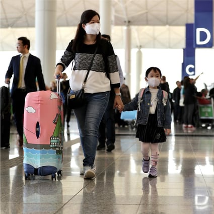 A family with a young child at the check-in halls of the Hong Kong International Airport. Photo: Bloomberg