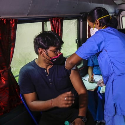 An India health worker administers shots during a drive-in vaccination program in Kolkata. Photo: AP