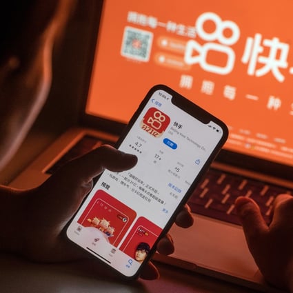 The Kuaishou app download page on a smartphone is seen in front of the company’s website. Photo: Bloomberg