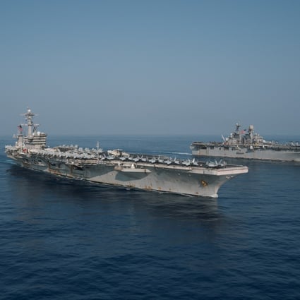 The Theodore Roosevelt Carrier Strike Group transits in formation with the Makin Island Amphibious Ready Group in the South China Sea in April. Photo: Handout