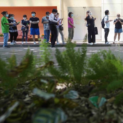 Hong Kong residents queue for their vaccine doses at Lai Chi Kok Park Sports Centre on June 16. Photo: Winson Wong