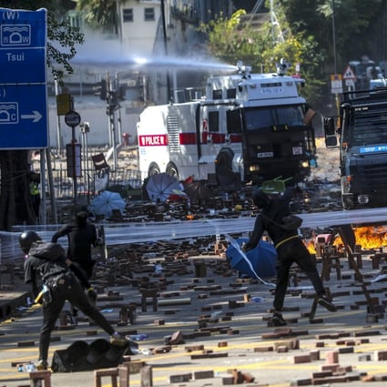 Two water cannon and an armoured vehicle arrive as clashes break out between riot police and students near Polytechnic University on November 17, 2019. Photo: Sam Tsang