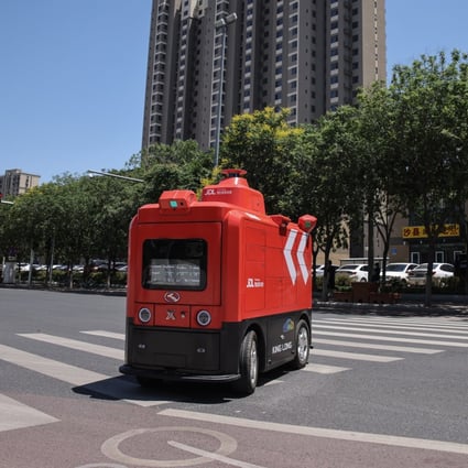 A JD.com unmanned distribution vehicle delivers goods in Beijing, China, in June. Photo: EPA-EFE
