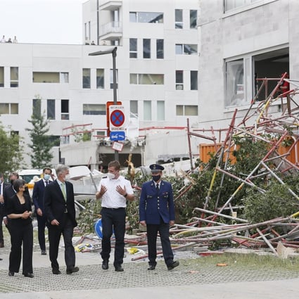 King Philippe of Belgium, centre left, visits the site of a building that partially collapsed in Antwerp, Belgium on Saturday. Photo: EPA-EFE 