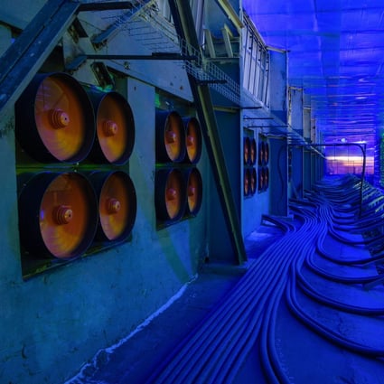 Industrial cooling fans operate to thermally regulate illuminated mining rigs at the CryptoUniverse cryptocurrency mining farm in Nadvoitsy, Russia, on March 18. The rise of bitcoin and other cryptocurrencies has prompted the greatest push yet among central banks to develop their own digital currencies. Photo: Bloomberg