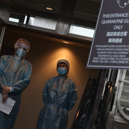 Staff members stand ready outside the Sheraton Hong Kong Hotel in Tsim Sha Tsui, one of the city’s designated quarantine hotels, on June 22. Photo: K.Y. Cheng