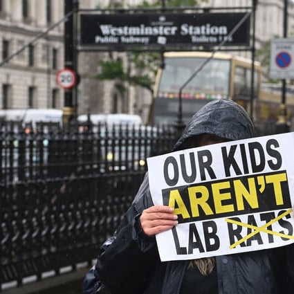 An anti-lockdown demonstrator holds a placard during a rally in Westminster in London on June 21, as the UK government delayed a full reopening for a further four weeks, due to a significant rise in Delta variant of Covid-19 cases across England.Photo: EPA-EFE 